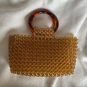 Elegant Beaded Handbag with Tortoise Like Handle